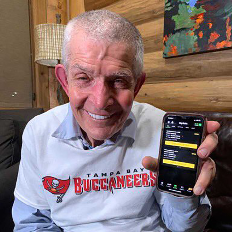 Mattress Mack holding up his phone after placing the $1 million bet on the Houston Cougars to win the 2021 NCAA men's basketball tournament.